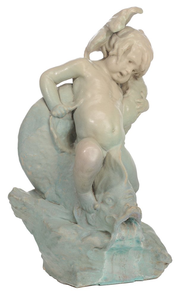 Large Rookwood Faience Fountain: Depicting a Child and Dolphin American, early 20th century, unsigned, 32-3/4 x 22 x 15 in., glaze crackle and scattered minor abrasions, mineral stains, accretion and some surface paint below dolphin'