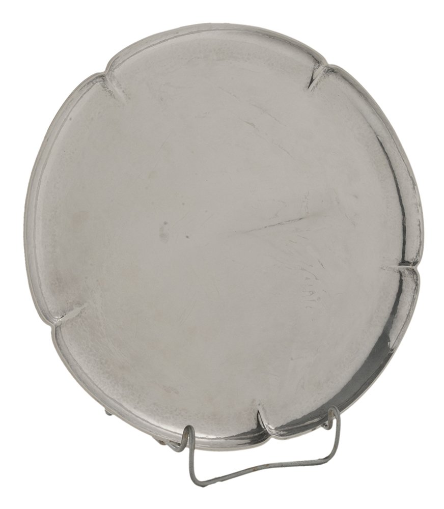 Kalo Sterling Tray: American, 20th century, round with scalloped rim, marks for The Kalo Shop, "F656", no monogram, 12.12 oz. T., 10 in., floor is buffed with loss to hammered finished, small dents. Provenance: Private C