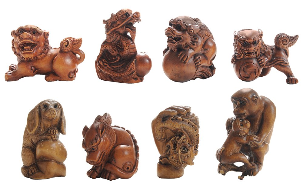 Eight Wood Carvings: Asian, 20th century, carved figure of seated dragon and pearl, inset glass eyes, signed, 2 in., [good condition;] finely carved seated foo lion, signed, 1-1/2 in.; netsuke in form of dog seated on a r