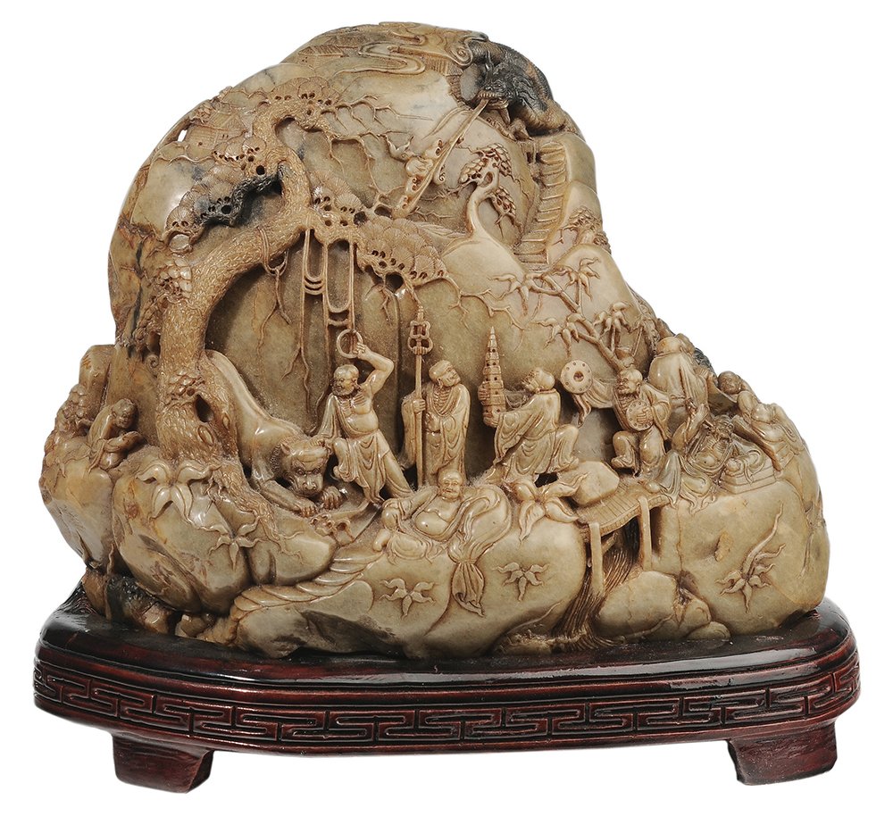 Figurally Carved Soapstone Boulder: Chinese, 20th century, amber to celadon color, with a procession of figures encircling the boulder, dragons, prunus branches and other symbols, 8 x 11 in., wooden base, good condition, light surface w