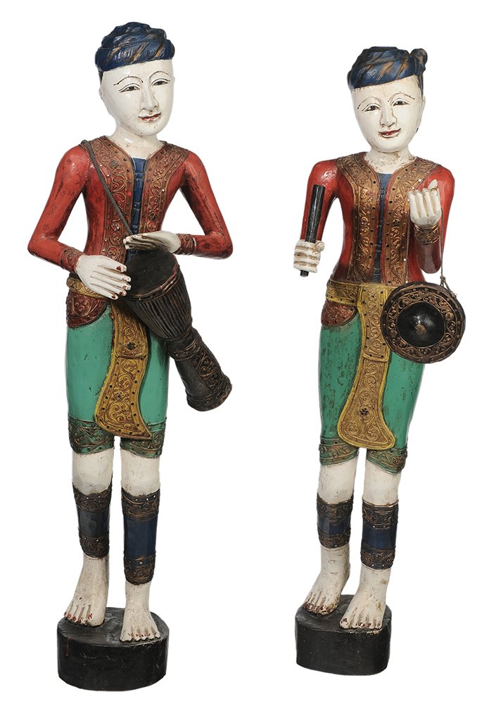 Two Carved and Polychromed: Wooden Musician Figures Thailand, 20th century, each in elaborate dress with gilt and jeweled vests, one holding carved wood drum, other cymbals, circular bases, 40 in. and 42 in., each with some crac
