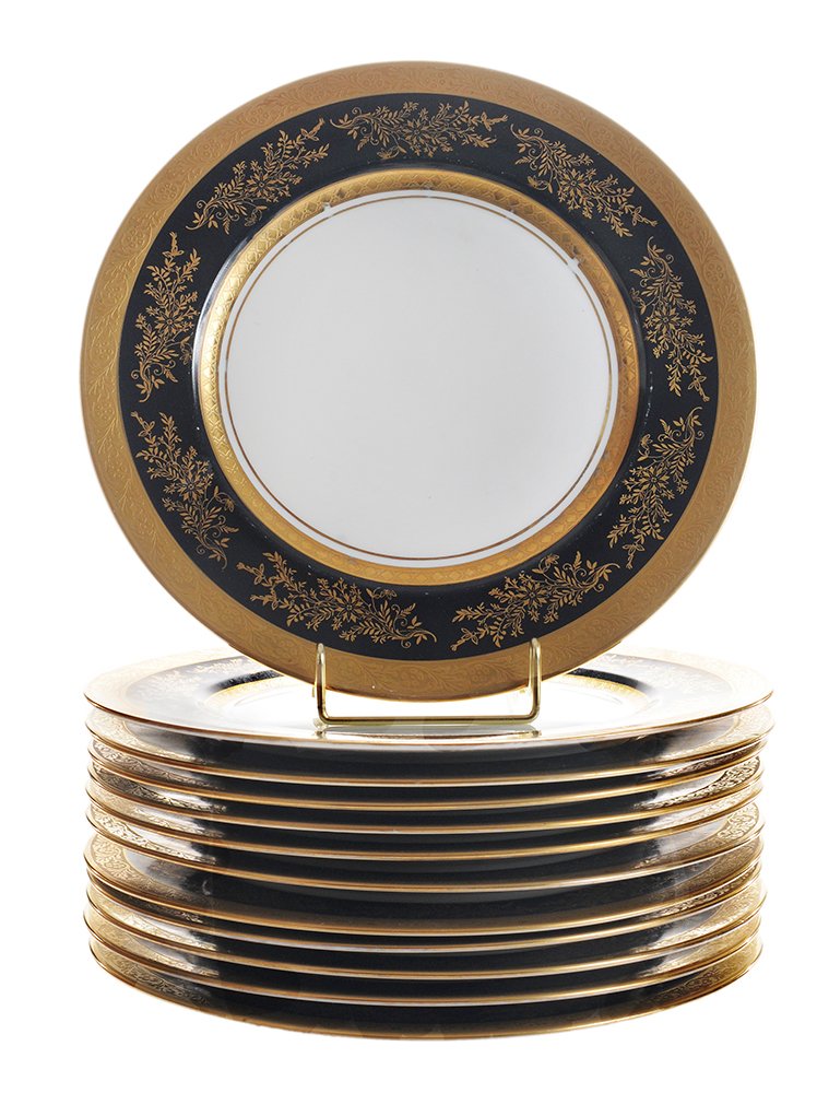 Twelve Bavarian Porcelain Service: Plates German, 20th century, each with white center, black rims with gold floral and vine decoration, gilt borders, stamped below crown "H&C Selb Bavaria Heindrich & Co.", 11 in., some gilt losses to 