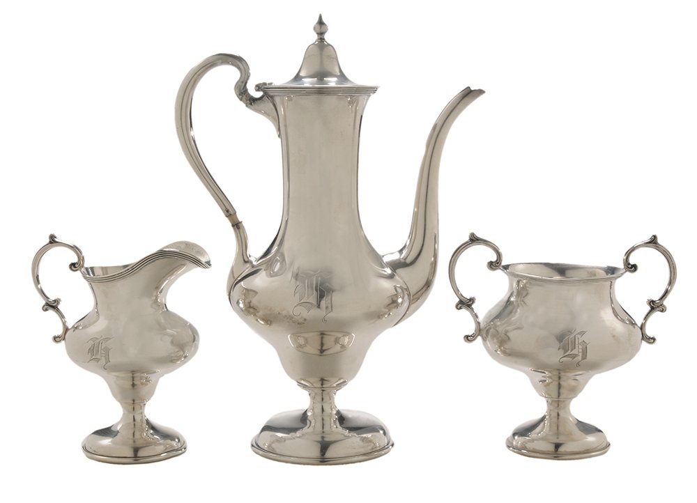 Three-Piece Sterling Coffee Service: American, 20th century, elongated urn forms, scroll handles, marks for Watson, monograms, 22.68 oz. T., 10 in. coffee pot with matching creamer and sugar, coffee pot handle loose, spacers replaced wit