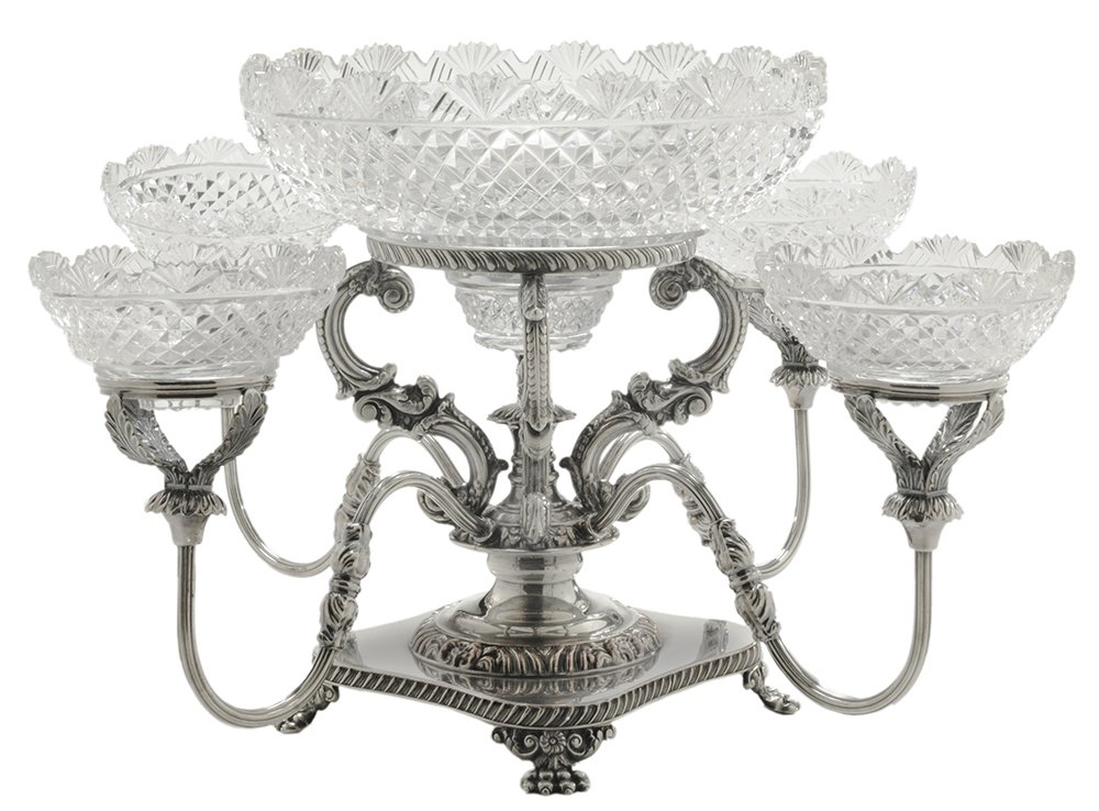 Sheffield Four-Arm Epergne: English, 20th century, central support with floral mount and four scrolling arms with cut glass bowls with fan rims over diamond centers, circular base with animal paw feet, cut center bowl with confo