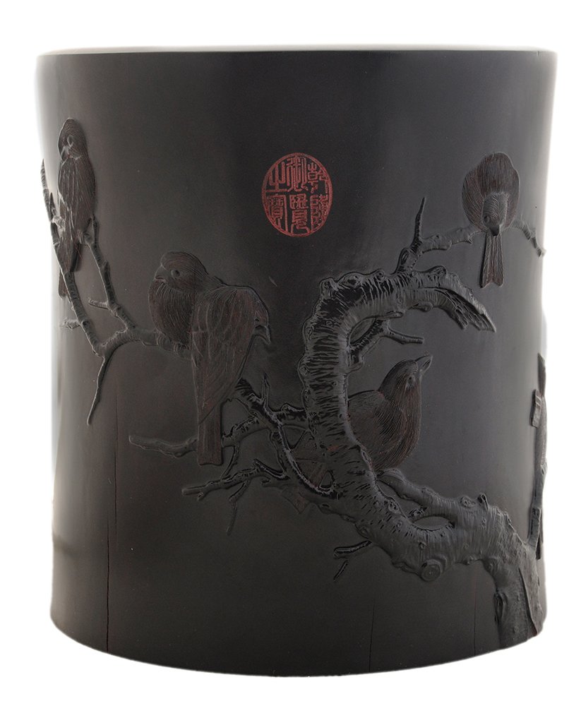 Carved and Black-Lacquered: Hardwood Brush Pot Chinese, 20th century, body carved with birds on a branch and stamped with calligraphy poetry, red chop at top, circular base, 9-1/4 in. wear at inside of top rim, extensive shrinka