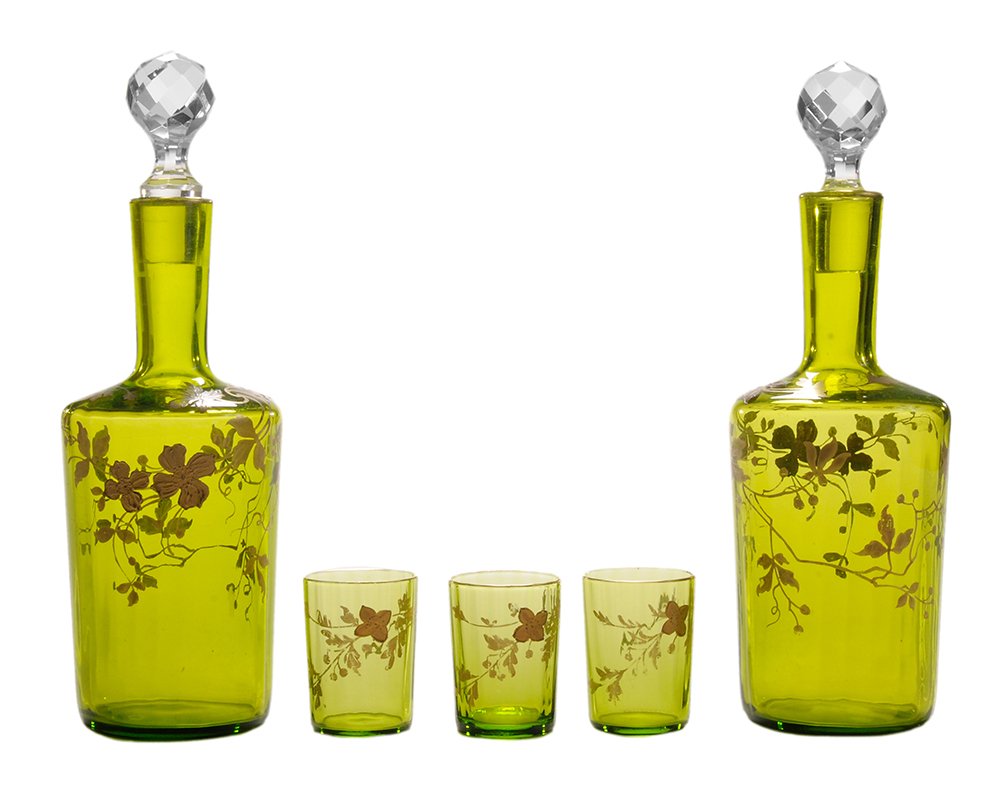 Two Moser Decanters, Eight Matching: Shot Glasses German, 20th century: two green decanters, bodies with leaves and berries, clear stoppers and gilt rims, 8-3/8 in.; with eight matching crystal shot glasses, 1-7/8 in., minor gilt losses