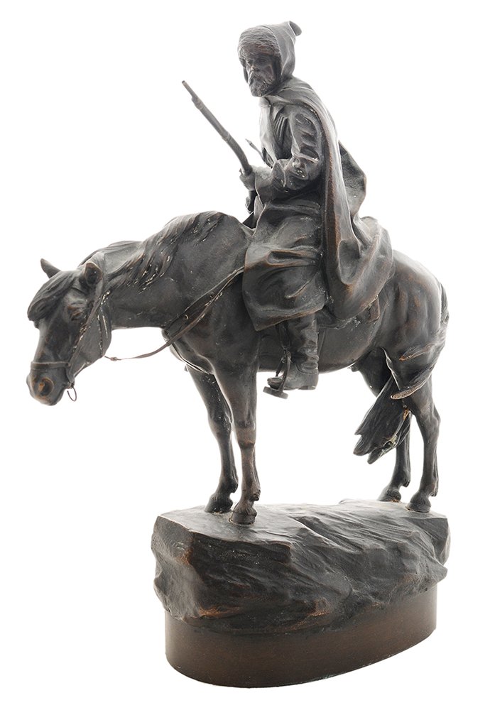 Albert Moritz Wolff: (German/Russian, 1854-1923) A Caucasian Cavalryman with Rifle, signed on base in cyrillic "A.M. Вольфъ", patinated bronze, 11-1/2 x 9 x 3-1/2 in., dark brown to bla