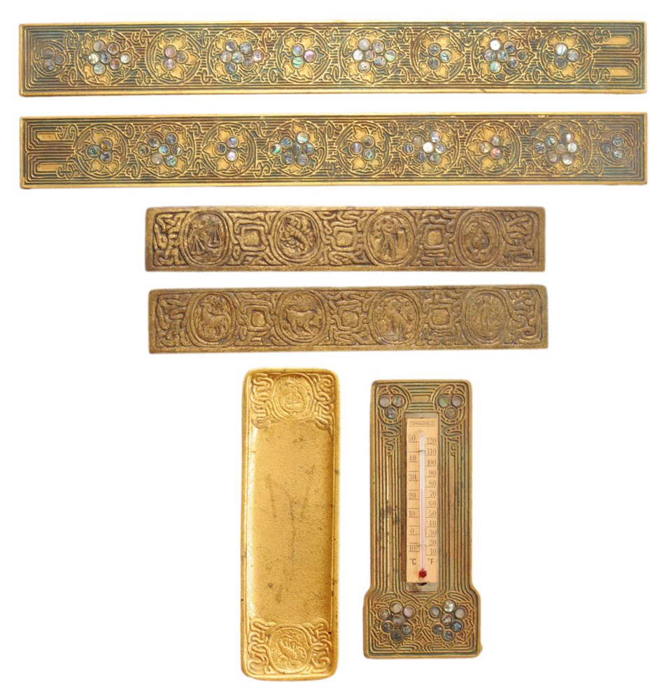 Group of Tiffany Bronze Desk Articles: American, late 19th/early 20th century, comprising an abalone-inlaid thermometer marked "Tiffany Studios New York 1167", 8-1/2 x 3-1/2 in.; Zodiac pattern gilt pen tray marked "Tiffany Studios New Yor
