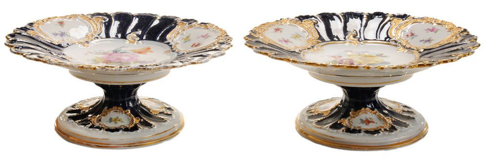 Pair Meissen Porcelain Compotes: German, late 19th/early 20th century, hand-painted and gilt decorated with finely scalloped borders, floral centers, three floral vignettes on cobalt ground, pedestal bases, crossed swords marks in un