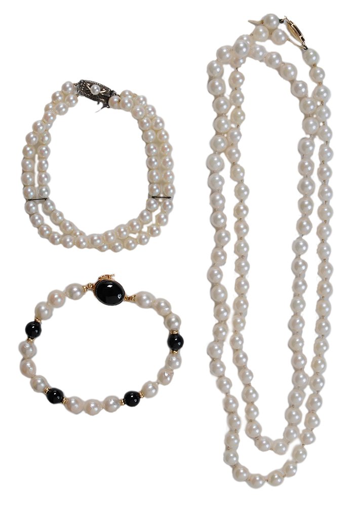 Pearl Necklace and Bracelets: single strand necklace of 100 near round cultured pearls, 6.5 mm. to 7 mm. plain navette-shaped 14 kt. yellow gold clasp, 31 in., some nacre losses, needs restringing; one double strand bracelet of 60