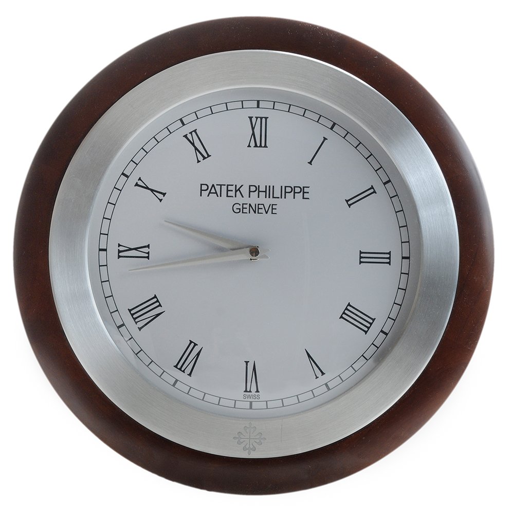 Patek Philippe Geneva Mahogany-: Framed Circular Showroom Clock Switzerland, 20th century, printed white dial with Roman Counters, aluminum hands, brushed aluminum and wood-grained circular case, quartz battery-operated works, stampe