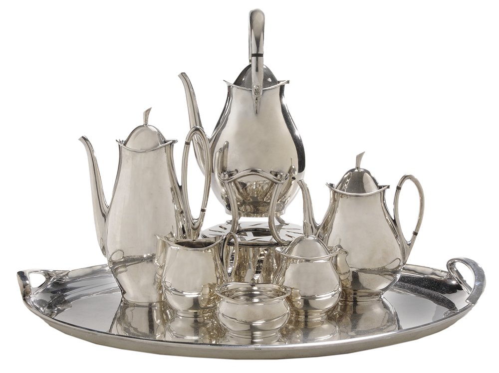Six-Piece Sterling Tea Service and: Tray Mexican, mid-20th century, elongated modern form and stem form finial, wooden spacers, no monograms, 16 in. hot water kettle with matching coffee pot, teapot, creamer, covered sugar, waste and tr