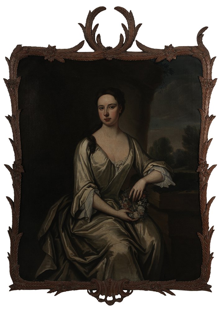 Attributed to Charles D'Agar: (French, 1669-1723) Portrait of a Young Woman Holding a Wreath of Flowers, said to be Lucy Pitt (1692-1723), unsigned, oil on canvas, 50 x 40 in.; carved wood frame with foliate and feather or leaf de