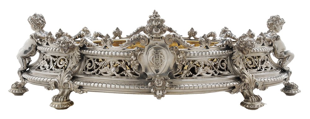 Odiot French Silver Centerpiece: French, late 19th/early 20th century, shaped oval, openwork sides, figural bust, griffins, floral baskets, acanthus and scroll decoration, removable full figure putti at each end, six double paw and g
