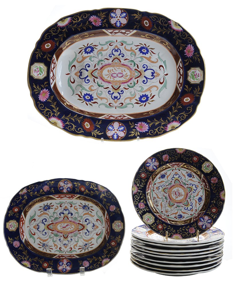 Twelve Pieces Ashworth Ironstone China: Central Flower and Twirls English, footed well-and-tree platter, 22 in.; platter, 13-1/4 in., loss to glaze on light blue twirls; ten dinner plates, 10-1/8 in., four with losses to glaze on light blue