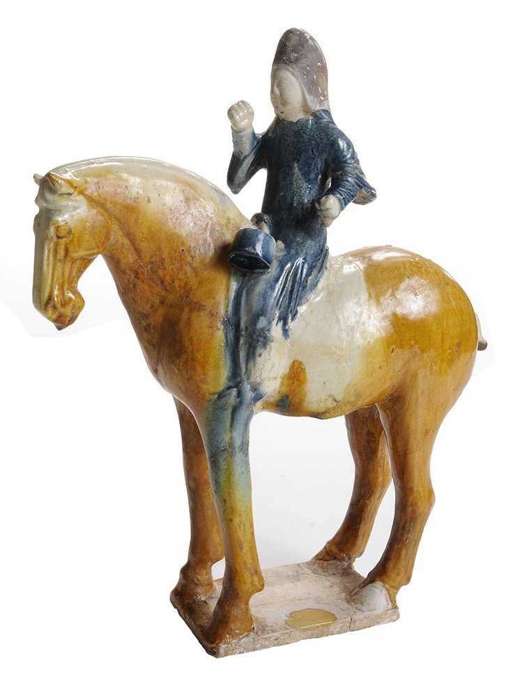 Early Chinese Glazed Earthenware: Figure of a Horse and Rider probably Tang Dynasty, not TL tested but thought to be of the period, 13-7/8 in., extensive breaks and repairs with associated retouch and scattered glaze losses;. Provenan