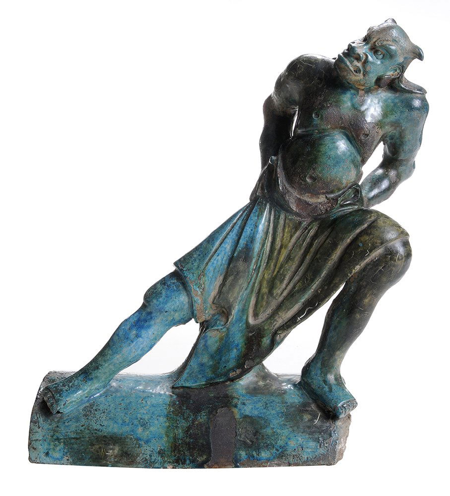 Antique Chinese Earthenware Roof: Tile with Figure of a Demon probably Ming period, fierce demon figure depicted with hands on hips and standing at an angle on a sloping roof, 13 x 11-1/2 in., extensive glaze losses with associated re