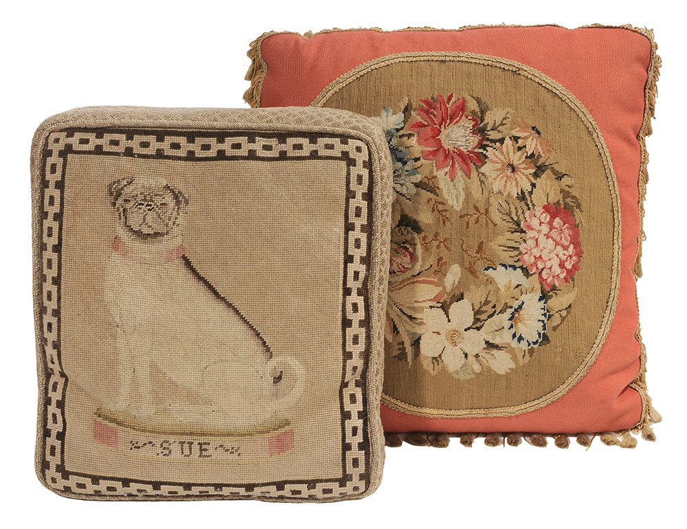Two Needlework Pillows: 20th century, one with Pug dog needlework panel, "Sue" below, later upholstered case, 13 x 12 in.; one with needlework floral wreath panel, applied fringe, 14 x 15 in. wear and fading to both.