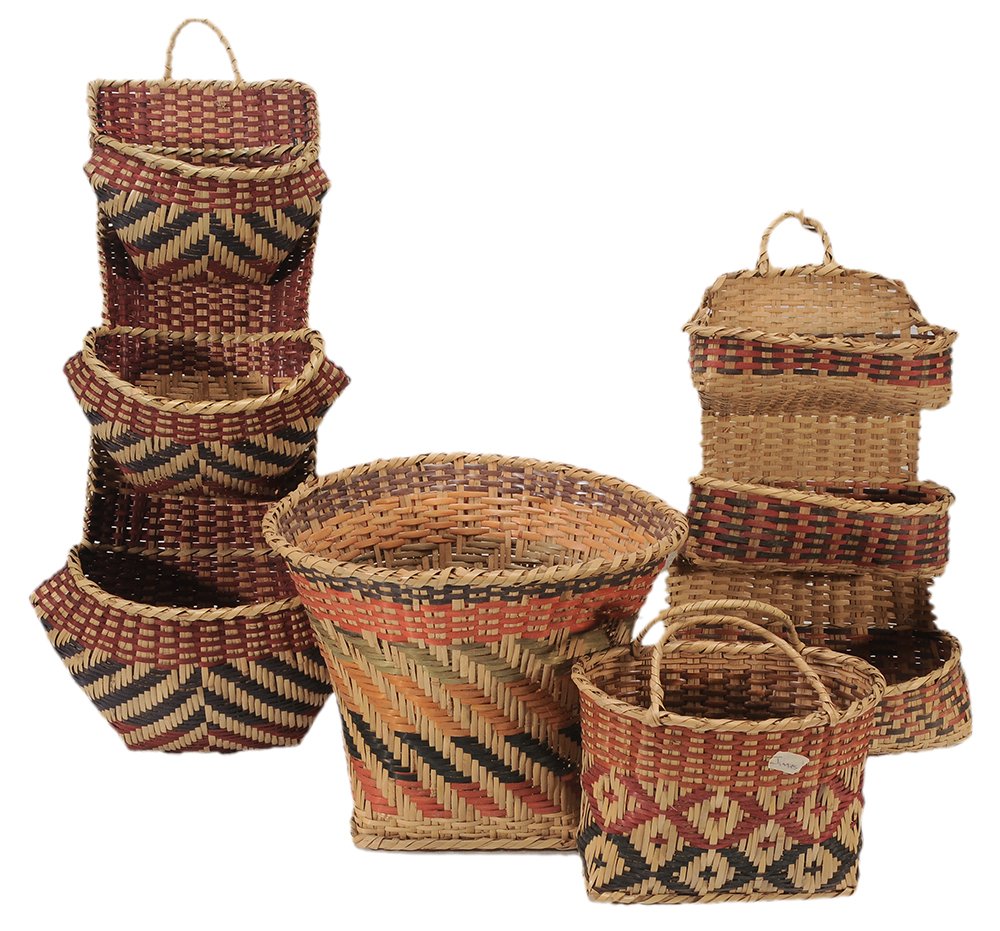 Four Choctaw River Cane Baskets: 20th century, aniline dyes: two wall pockets, 21 in. and 30 in.; waste basket, 12 x 15 in.; purse basket, 11 x 10-1/2 x 7 in., some abrasions, broken weavers and fading. Provenance: Private Collection