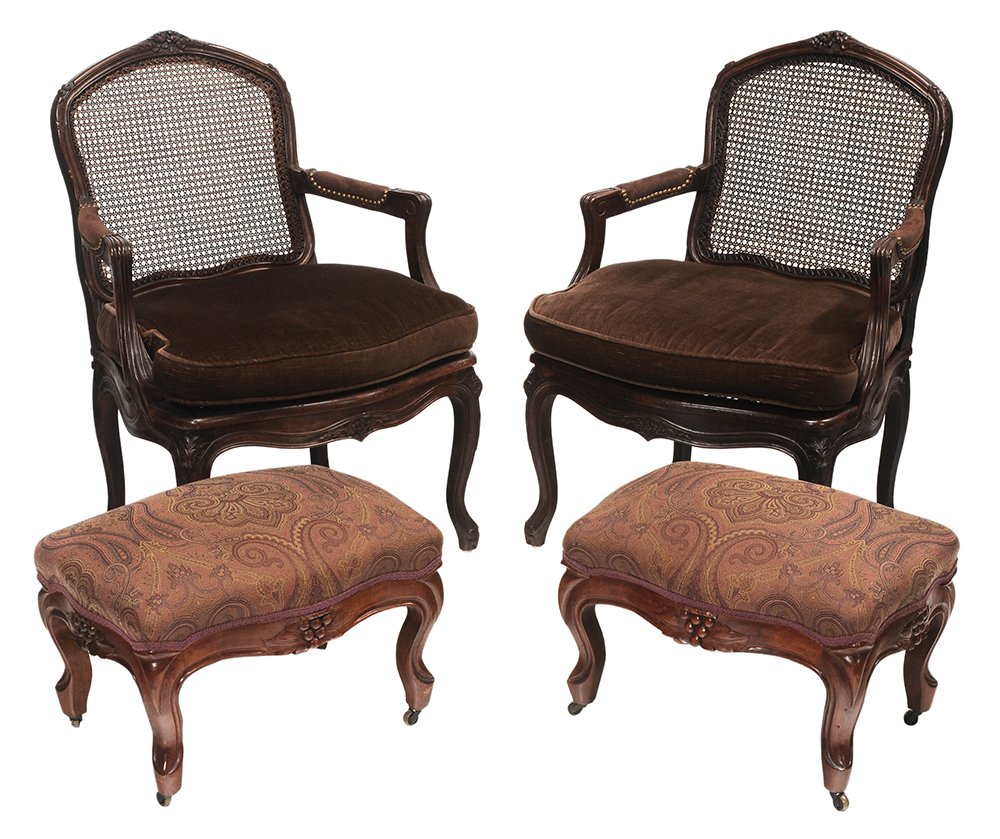 Pair Louis XV Style Carved and: Caned Open-Arm Chairs, Pair Footstools chairs with carved crests, knees and front seat rail, leather-upholstered arms, caned backs and seats, seats set with loose cushions, 20th century, 37-1/2 x 26 x
