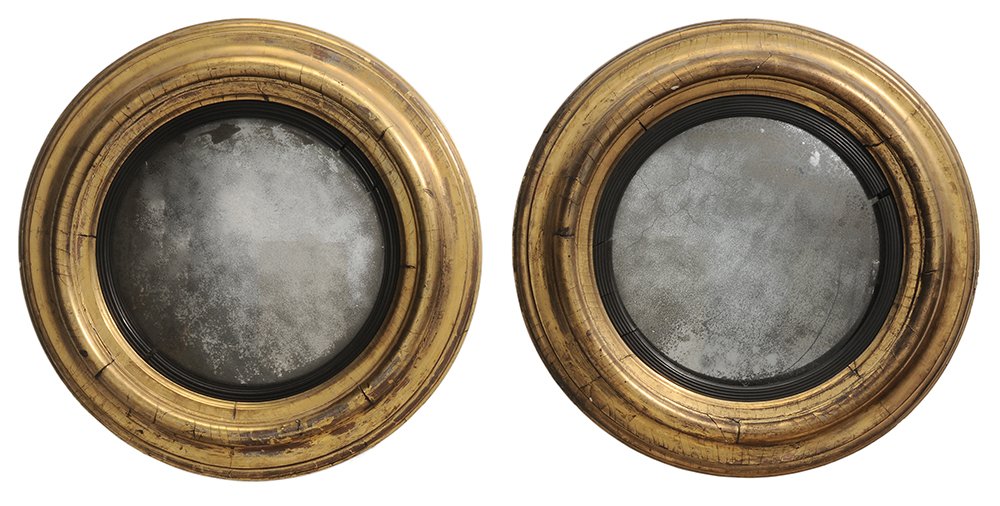 Pair Regency Gilt and Ebonized: Convex Mirrors British, 19th century, each with gilt molded frame centering a reeded ebonized liner with distressed convex mirror plate, 25 x 25 in., mirror plates probably original (not removed) and 