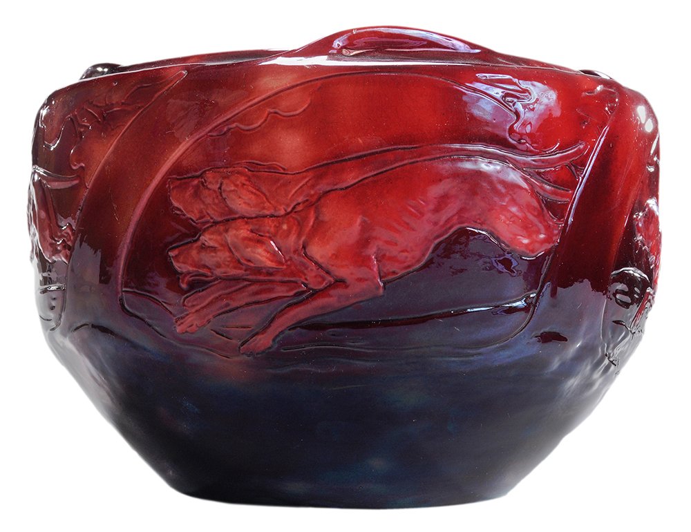 Zsolnay Stoneware Jardinière: Pecs, Hungary, circa 1900, probably by Sandor A. Pati, low-relief hunt scene of hounds chasing a rabbit through trees, red glaze outside, green glaze inside, relief five church-steeples mark on bottom