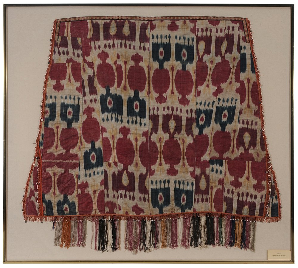 Ikat Horse Cover: Central Asia, probably 19th century, pieced cotton Ikat cloth, brocaded trim, beaded fringe on three sides, 50 x 57 in. (sight), metal frame 57-1/2 x 64 in., scattered stains, wear, fringe loss, not e
