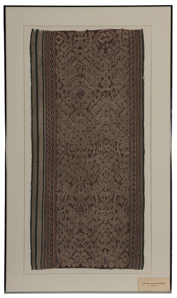 Child's Ikat Sarong: attributed to Eban tribe, Kalamatam, Indonesia, beige, rust and blue in geometric designs with borders, 38 x 18 in. (sight); metal frame 46 x 27 in., faded, wear to borders, not examined out of frame.