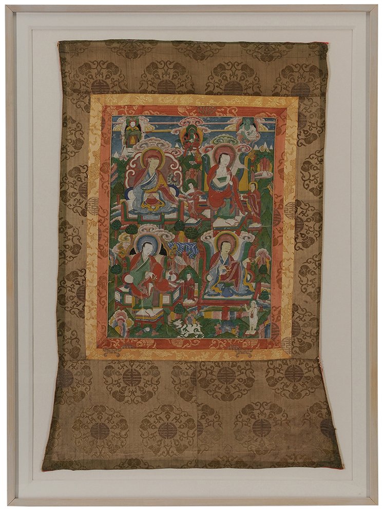 Tibetan Tanka: early 20th century, painting of Buddhist figures with multiple brocaded silk borders, 45-1/2 x 33 in. (sight); wood frame 54 x 40 in., abrasions to Tanka surface, fading to silk, not examined out of f