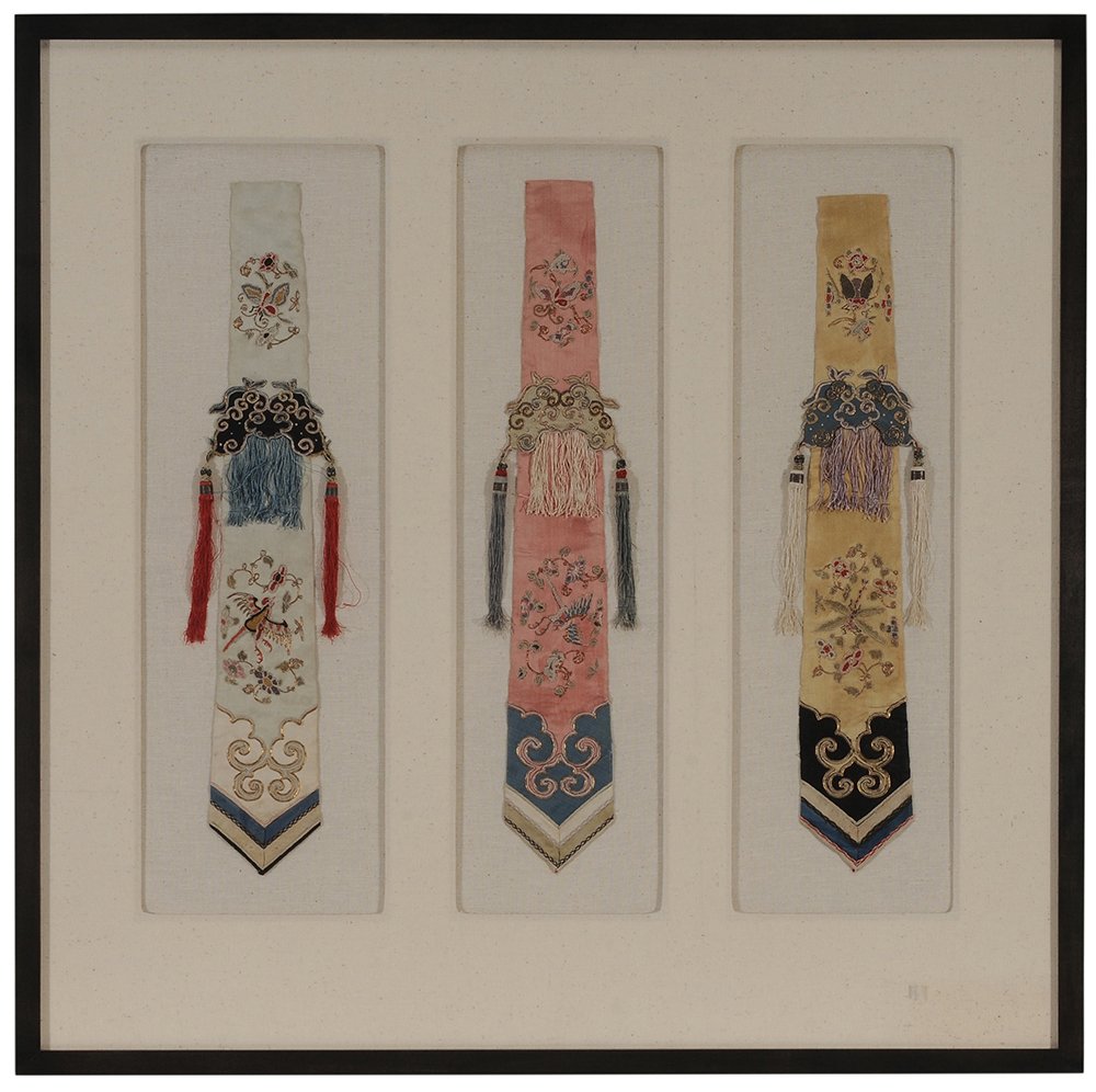 Three Embroidered Silk Sashes: China, Qing Dynasty, framed together, finely embroidered with birds, butterflies and exotic plants, silk and couched metallic thread on silk ground, tassels on each side, each approximately 20 x 3-3/4