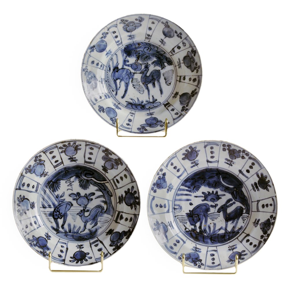 Three Ming Kraak Ware Blue and White: Porcelain Shallow Dishes with Stags Chinese, circa 1575-1640, centers with two deer in a landscape, segmented border with peaches and sunflowers, unglazed foot, unmarked, 8 in., each with minor losses