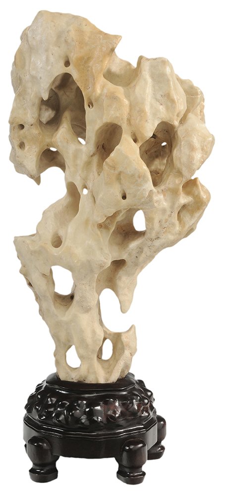 Lake Taihu Scholar's Rock: on Carved Hardwood Stand Chinese, limestone example of ivory color with delicate bridges, tunnels, caves, caverns and small mountains, on finely carved hardwood base, 29 in. overall, wooden base crack