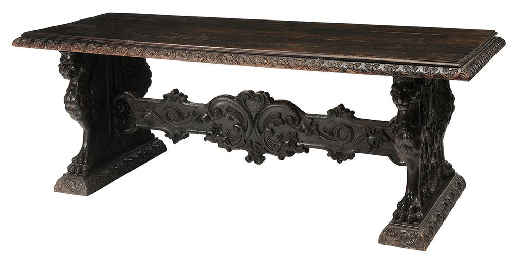 Italian Renaissance Style Carved: Walnut Library Table flower-carved molding over a trestle-form base set with bold winged-griffin supports centering on the end a shield device, carved stretcher, 32 x 89-1/2 x 34 in., top with warping