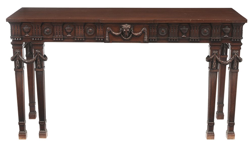 Edwardian Adam Style Carved Mahogany: Pier Table or Server British, late 19th/early 20th century, two dovetailed drawers with mahogany linings, ram's head, urn and swag-carved frieze, 36-1/2 x 66-7/8 x 23-3/8 in., breaks and repairs to sw