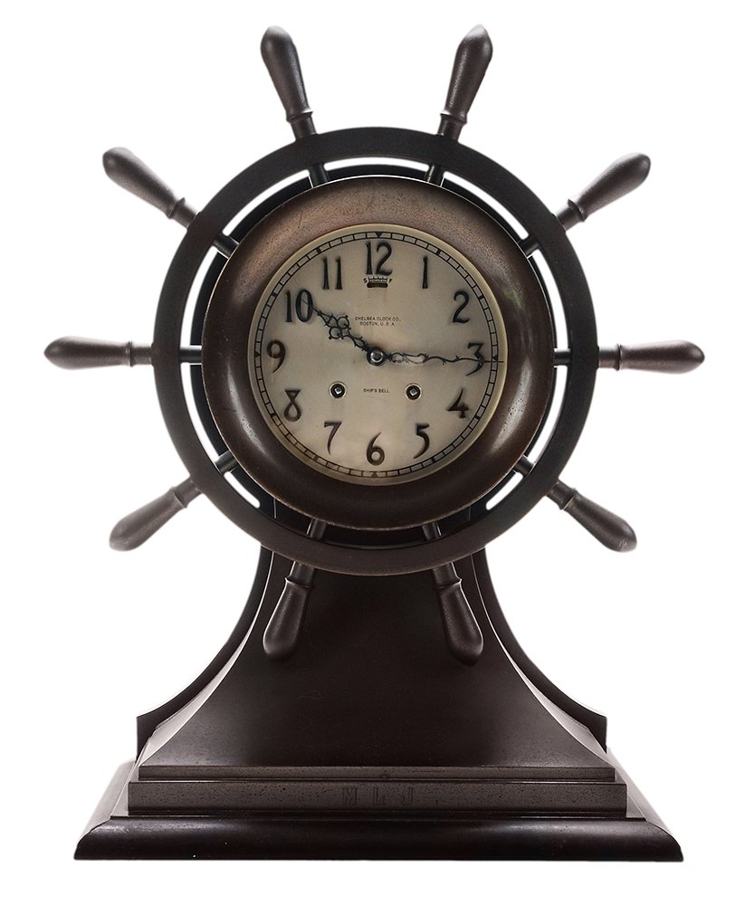 Large Chelsea Ship's Bell Yacht-Wheel: Mantle Clock Chelsea Clock Co., Boston, Massachusetts, monogram on platform base "MLJ", steel dial engraved "CHELSEA CLOCK CO./BOSTON USA/SHIP'S BELL", ebonized wooden platform base and backplate, wit