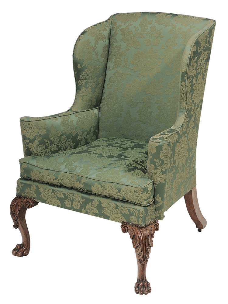 George III Carved Oak and Damask-: Upholstered Wing Chair British, probably late 18th/early 19th century, with curved back and wings, rolled arms, set with loose down cushion, on bold leaf and animal paw carved front legs with some ear