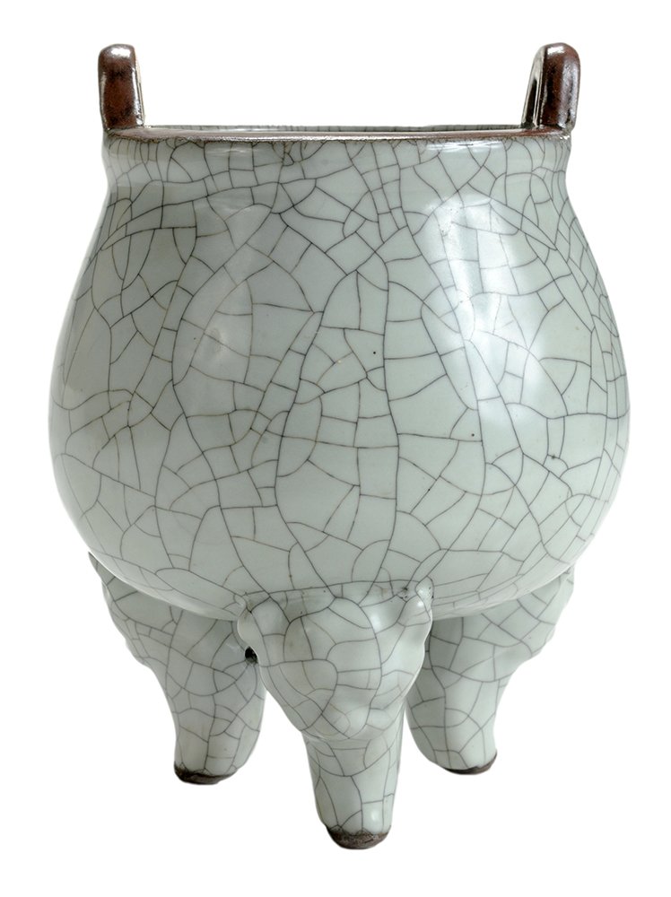 Pale Celadon Ceramic Crackle Glaze: Incense Burner Chinese, early 20th century, brown glaze top rim, double loop handles, body with overall pale crackle glaze raised on three animal head splayed feet, 8-1/4 in. minor firing flaw, one bl