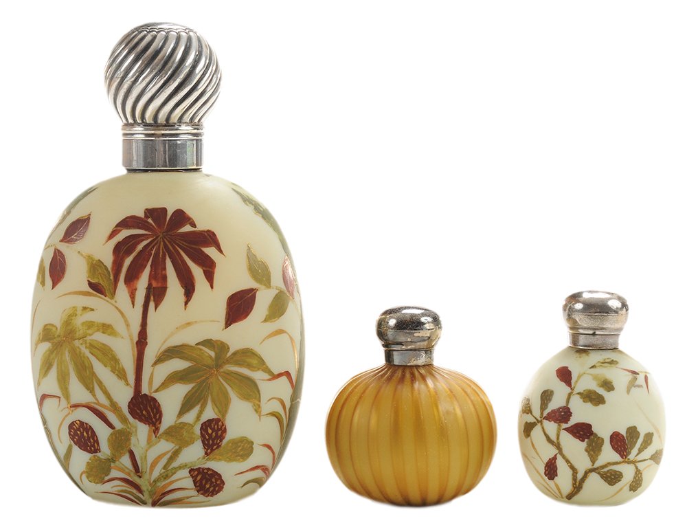Three Thomas Webb & Sons Bottles, One: Cologne, Two Perfumes English, late 19th century, two flattened oval form, enameled on white glass, matte-finished, maroon, olive and gilded tropical foliage, larger with marks for Hillard & Thoma
