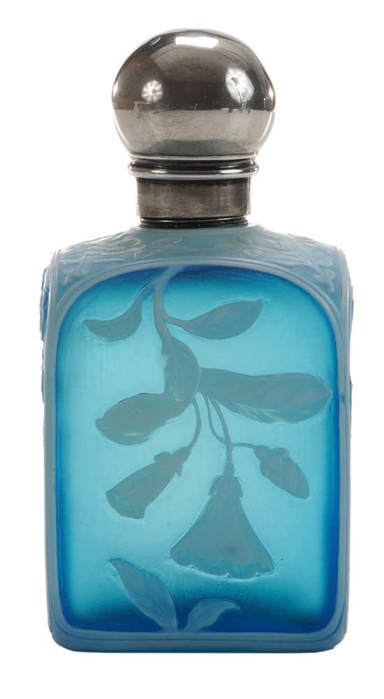 Thomas Webb & Sons Cameo Glass Cologne: Bottle English, 1883-4, opal tinted over pale blue over blue crystal, each side carved with a separate and botanically correct flower, shoulder delicately carved, not carved through to blue, giving la