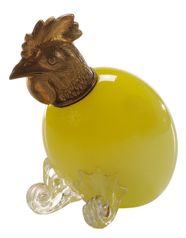 Thomas Webb & Sons Yellow Egg-Shaped: Perfume Bottle English, late 19th century, realistically colored as egg yolk, gold-colored metal screw top formed as chicken head, scrolled “feet,” 3-1/2 in. good condition. Notes: Novelty perfume