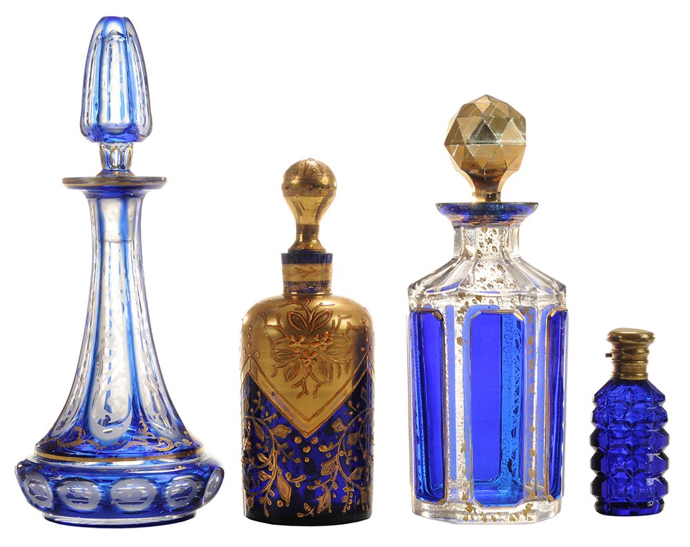 Four Cobalt Perfume Bottles: Bohemian, English/Continental, 2nd half 19th/early 20th century, some bottles cut, others with fine enameling, heavy gilding, two with silver caps, 3 in. to 6-1/4 in. light wear to bases, losses to gi