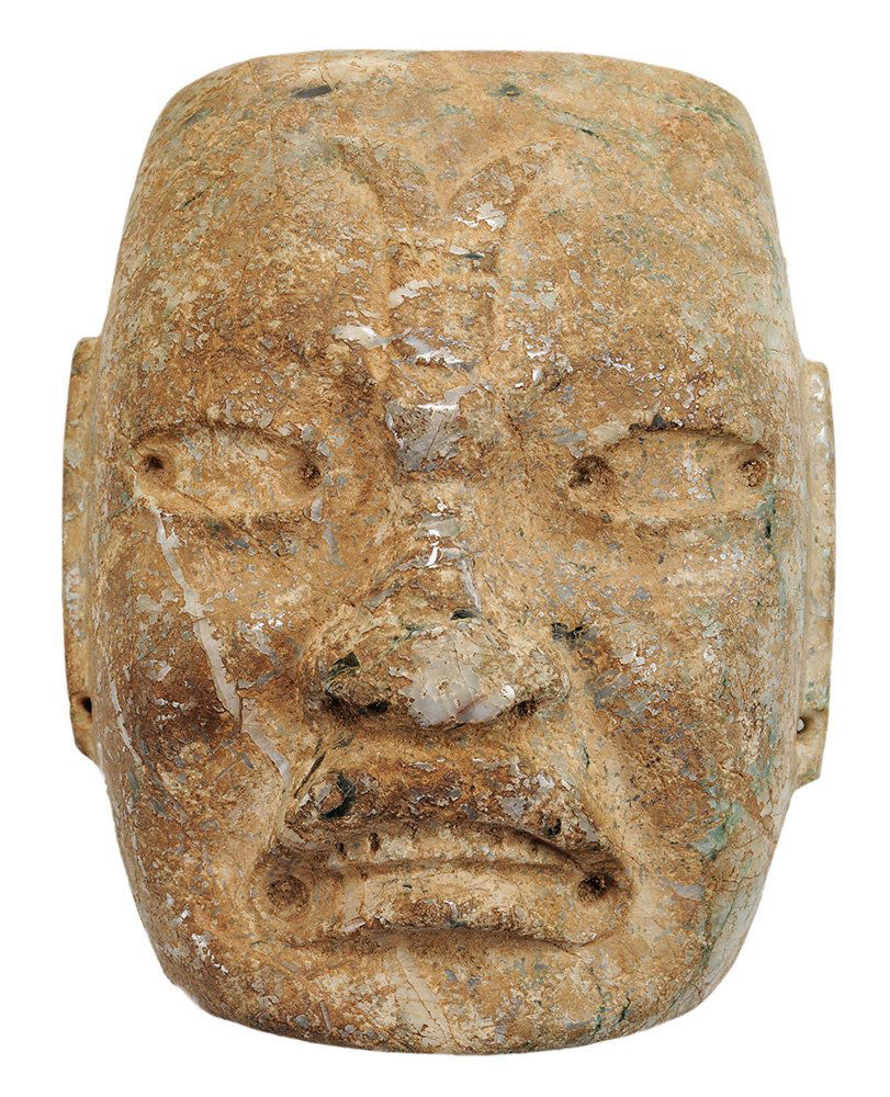 Pre-Columbian Carved River Jade: Funerary Mask Possibly Mayan or Olmec late Classical period, carved of a single piece of river jade, mask with open eyes, downturned mouth, exposed teeth, stylized ears with drill holes, concave verso
