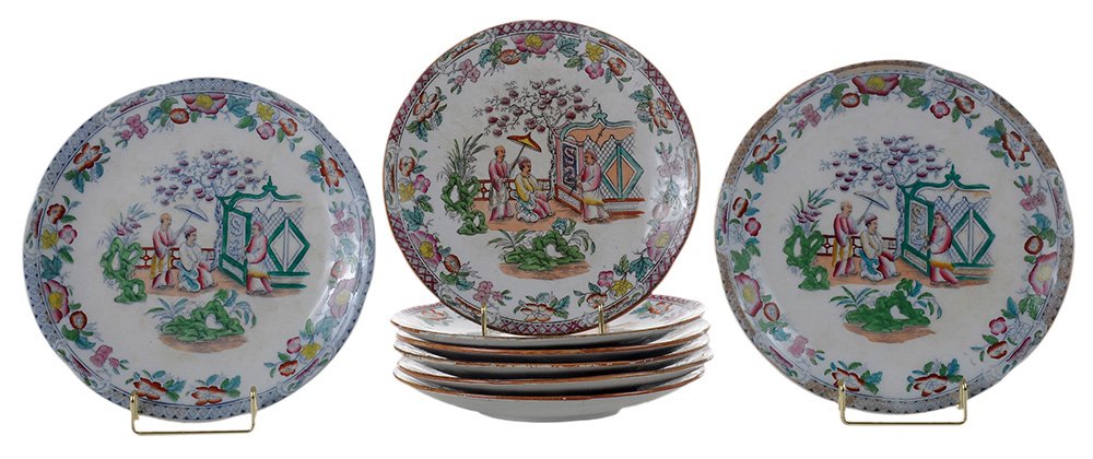 English Ironstone Dessert Service: 19th century, four pedestal plates, 2-7/8 x 9-3/4 in., and 12 dessert plates, 9 in., with blue transfer prints enhanced with red, pink, green and yellow glazes of Chinese figures in a garden surrounde