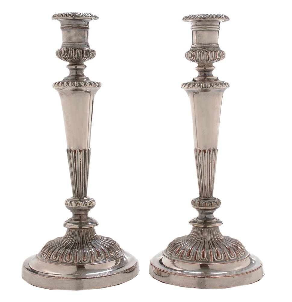 Pair of Matthew Boulton Old Sheffield: Plate Candlesticks Sheffield, late 18th/19th century, tapering posting with gadroon borders, urn form socket, marked with twin suns for Matthew Boulton, no monogram, 12-1/4 in., loss to plate, small d