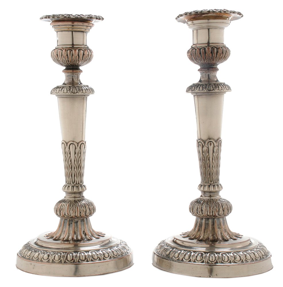Pair of Matthew Boulton Old Sheffield: Plate Candlesticks Sheffield, late 18th/19th century, urn form socket, egg and dart borders, tapering post with acanthus leaf decoration, marked with twin suns for Matthew Boulton, no monogram, 9 in.,