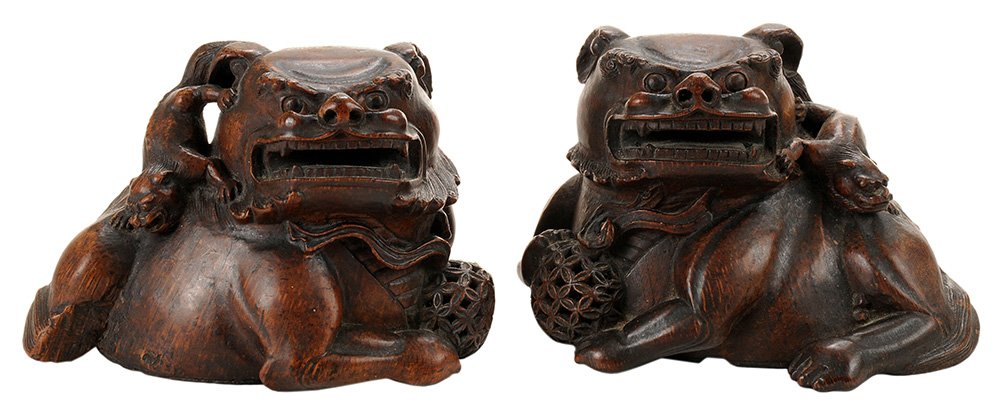 Rare Pair Antique Chinese Carved: Bamboo Root Figural Wine Cups Qing Dynasty, 17th/18th century, in the form of a finely matched pair of Buddhist lions with a [bixie] at their shoulder and depicted holding a brocade ball, each flatten