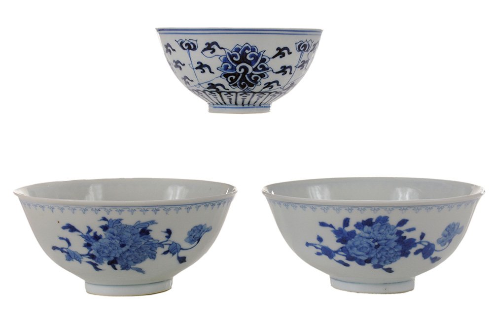 Three Blue and White Porcelain Bowls: Chinese, one pair with penciled decoration, exterior with three panels of peonies, 2-1/4 x 5 in., [both in good condition;] one with lotus and scrolling vine, 2-1/8 x 4-5/16 in. diameter, [rim chips,]