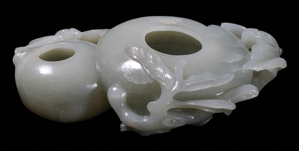 Celadon Jade Double-Gourd Brush Washer: Chinese, pale celadon finely carved in high relief with openwork, the waisted midsection surrounded by gnarled branches with large leaves and curly vines, the sash securing sprays of lingzhi and nandi