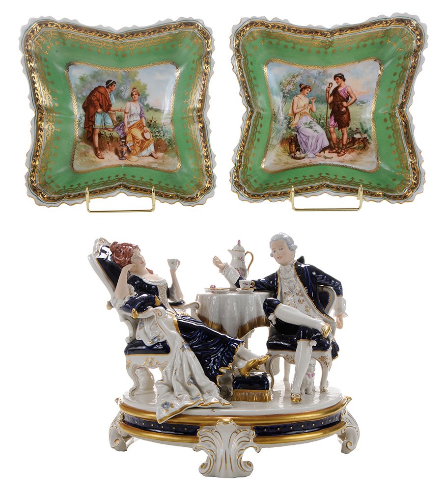 Royal Dux Tea Drinkers and: Two Austrian Dishes Dux, Bohemia (now Czech Republic), Duxer Porzellanmanufaktur, early 20th century, large porcelain figure group featuring a man and woman dressed in 18th century blue and white cost