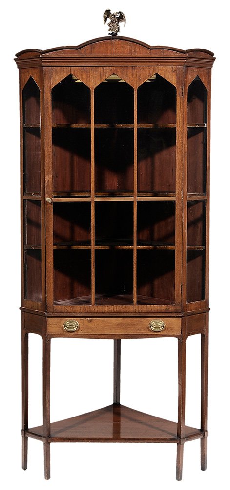Continental Baroque Walnut Corner: Cupboard 19th century, scalloped cornice over a single glazed door opening to a fixed shelved interior over a single drawer, eagle finial, 74-1/4 x 33-1/2 x 21-1/4 in.